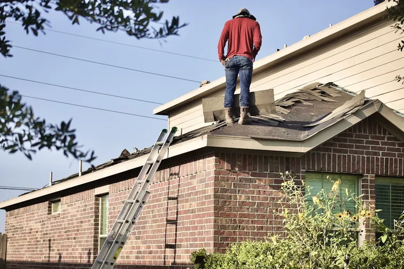 Professional roofer working on a residential roof in Elyria